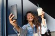 © Oscar - Woman taking selfie holding iced coffee drink