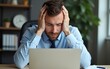 © Owen - Business man got migraine touches her head because of pain. Man manager with strong headache working on laptop. Overworked freelancer or manager at office. Stressed, tired man with headache.