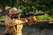 © ADDICTIVE STOCK - Airsoft enthusiast in camouflage during outdoor training