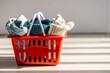 © ADDICTIVE STOCK - Clothing items in a red basket on a bright wooden floor