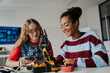 © Halfpoint - High school students working on robotics project. Girls in STEM.