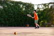 © ADDICTIVE STOCK - Teen boy engaged in tennis practice on a sunny court