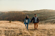 © La Famiglia - Couple hiking holding hands enjoying autumn nature outdoors