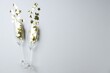 © New Africa - Merry Christmas and Happy New Year. Flute glasses with golden star shaped confetti on white background, flat lay. Space for text