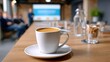 © stardadw007 - A close-up view of a coffee cup on a table in a meeting room, with a presentation screen and attendees visible in the background.