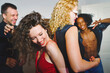 © Westend61 - Friends dancing and laughing together at a fun home party
