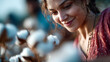 © Aliaksandra - Smiling woman examining cotton plants in a sunny field, depicting sustainable farming and agriculture