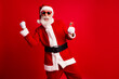 © deagreez - Energetic Santa Claus Holding Smartphone Celebrating Christmas on a Red Background with Fun and Modern Expressions