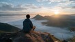 © t.sableaux - A solo traveler sits on a rock, admiring stunning mountains bathed in the soft light of a winter sunrise