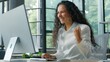 © Yuliia - Happy hispanic business woman win with computer in office ethnic businesswoman female girl manager typing pc winning excited online achieve success corporate victory glad rejoice good news celebrating