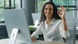 © Yuliia - Ethnic Hispanic Arabian business woman showing ok sign gesture in office typing computer businesswoman female girl using pc service online software recommend approve cyberspace corporate technology