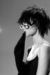 © SHOTPRIME STUDIO - Black and white woman wearing white sunglasses and black outfit with messy short hair in stylish pose