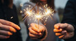 © Arra Vais - Holding sparklers with friends during celebration, bright festive glow of friendship. Sparklers in hands capture the joyous glow of celebration, sharing special moment with those around.