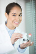 © auremar - happy scientist holding samples with positive testing solution