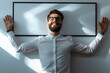© Fleuronica - Man Joyfully Posing With Arms Outstretched Against a Wall Holding an Empty Frame in a Well-Lit Indoor Space During the Day