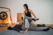 © phoenix021 - Thai yoga massage, woman masseuse  performing stretches that helps muscles loosen up