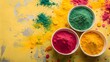 © Jaweria - holi background. bowls of colorful gulal powder on yellow table flat lay with copy space. festive indian happy holidays greeting card, invitation or banner. hindu festival of colours 8k backdrop. see