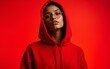 © ming - Fashion model posing in oversized red hoodie on red background. High quality