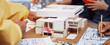© InfiniteFlow - A dynamic architectural design session where a diverse group of designers collaborate around a model and blueprints, sharing ideas and creativity. SACTR