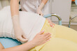 © Rabizo Anatolii - Pregnancy checkup. Gynecologist measures mother belly to assess the baby growth and development. Gynecologist tracks the baby growth by measuring the expectant mother belly size at prenatal visit.