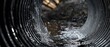 © Fernando - Water flowing through corrugated metal pipe, drainage system with splash and motion Concept of infrastructure, flood control, and environmental management