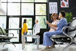 © DC Studio - Inside a medical clinic, nurse explaining radiography results to a patient during checkup. Diverse women discussing about health evaluation and treatment guidance. Lifestyle awareness.