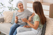 © Pixel-Shot - Mature woman after chemotherapy talking to her daughter at home