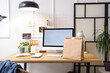 © Pixel-Shot - Workplace with computer and paper bag in office. Food delivery service
