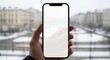© Tiang - Holding a blank smartphone screen with a blurry cityscape background in winter, Mobile phone, Hand, Blank screen
