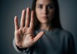 © NURUNNAHAR - Closeup of a womans face, out of focus, with her hand raised in a clear stop gesture, conveying a message of refusal and boundaries