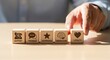 © QuiinL - A person's hand arranging wooden blocks with icons for support, feedback, experience, understanding, and loyalty to build customer relationships.