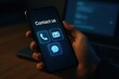 © ParinApril - User engaging with contact options on smartphone screen in a dark environment. Concept of digital communication, accessibility, and modern connectivity.