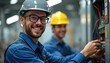 © miss irine - Two young electricians, wearing helmets and uniforms, smile while working on an electrical panel with wires and components. They are learning skills for a future career in vocational training.