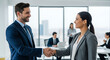 © Rakib - Smiling business professionals shaking hands in a modern office with colleagues in background