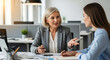 © Rakib - Two professional women in an office discussing business at a table