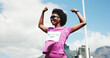 © peopleimages.com - Black woman, marathon and celebration with winning at finish line with low angle, goals and performance. Person, champion and happy runner with achievement, success and fist pump for sports milestone