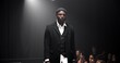 © peopleimages.com - Man, model and runway with luxury for fashion show, garment collection or designer brand. Male person, crowd or audience with clothing line or outfit for publicity or new aesthetic trend on catwalk