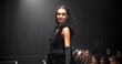 © peopleimages.com - Woman, model and catwalk with event for fashion show, garment collection or designer brand. Person, crowd or paparazzi with clothing line or outfit for publicity or new aesthetic trend on runway