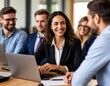 © Ирина Самойлова - A businesswoman holds a project meeting and works on a laptop in an office among colleagues.
