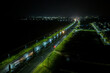 © AmazingAerialAgency - Aerial view of the illuminated Obirikwerre road stretching into the night with blurred car lights and bright streetlights, Port Harcourt, Rivers, Nigeria.