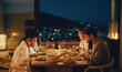 © Jacob Lund - Friends dining together at a cozy evening dinner in a modern home