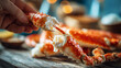 © Hype2Art - Hands pull crab legs apart at a dining table. A seafood feast with bright orange shells glows under warm ambient lighting.