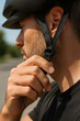 © thodonal - Man fastening helmet strap while preparing for cycling activity