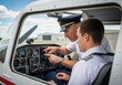 © logonv - Two men, pilot and student, in a small aircraft cockpit, pointing at instruments on the dashboard. Flight training concept for aviation school.
