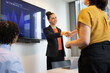 © ReeldealHD images - Young businesswoman in an office meeting the team with a handshake