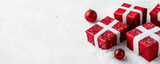 Red christmas gift box with white ribbon and snow on white background, festive decoration and ornament create joyful holiday atmosphere
