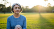 © Lucianastudio - An elegant senior woman with a peaceful and reflective expression is shown relaxing outdoors with the blurred greens and golden glow of the late afternoon adding a touch of serenity to the image