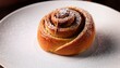 © Enver - delicious cinnamon roll on a white plate with sugar crystals and bite mark