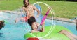 © vectorfusionart - Playing woman in swimsuit in green tube holding pink water blaster and splashing in backyard pool