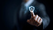 © sornram - A business professional interacts with an artificial intelligence shield symbol, highlighting security in the digital age.